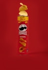 a can of pringles on a red background