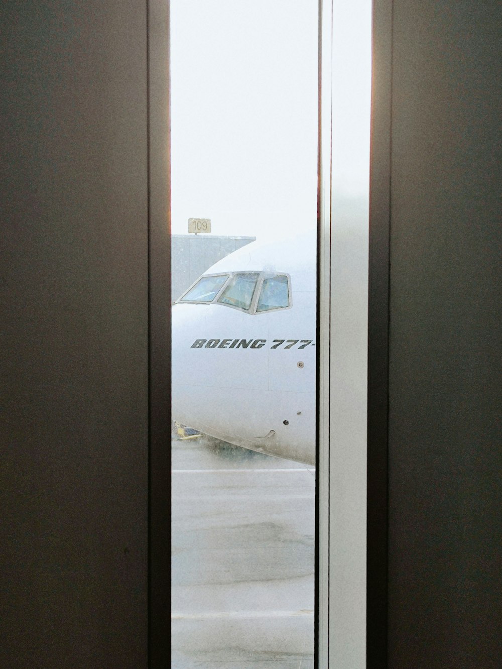 an airplane is seen through the open door