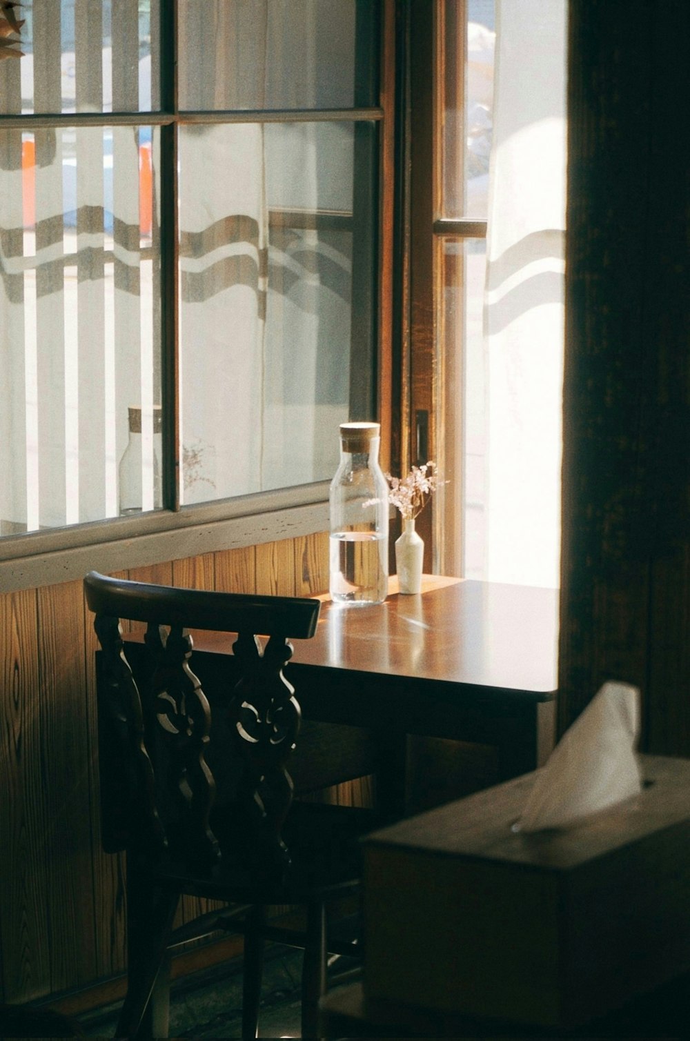 a wooden table sitting next to a window