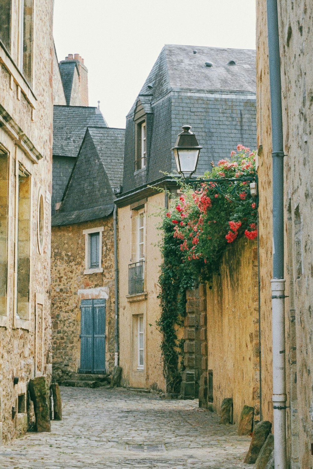 a cobblestone street lined with stone buildings