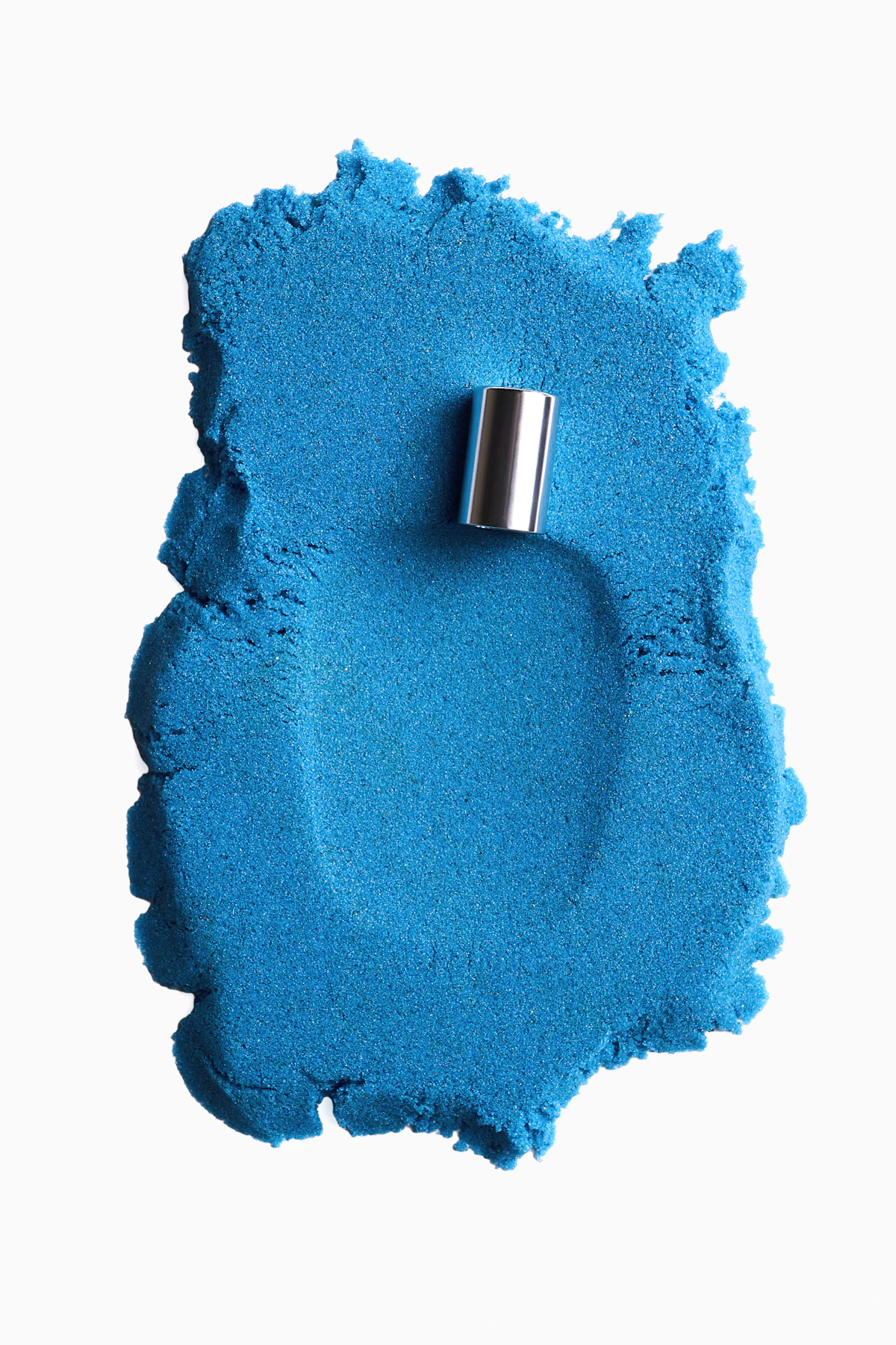 A close up of a blue powdered object