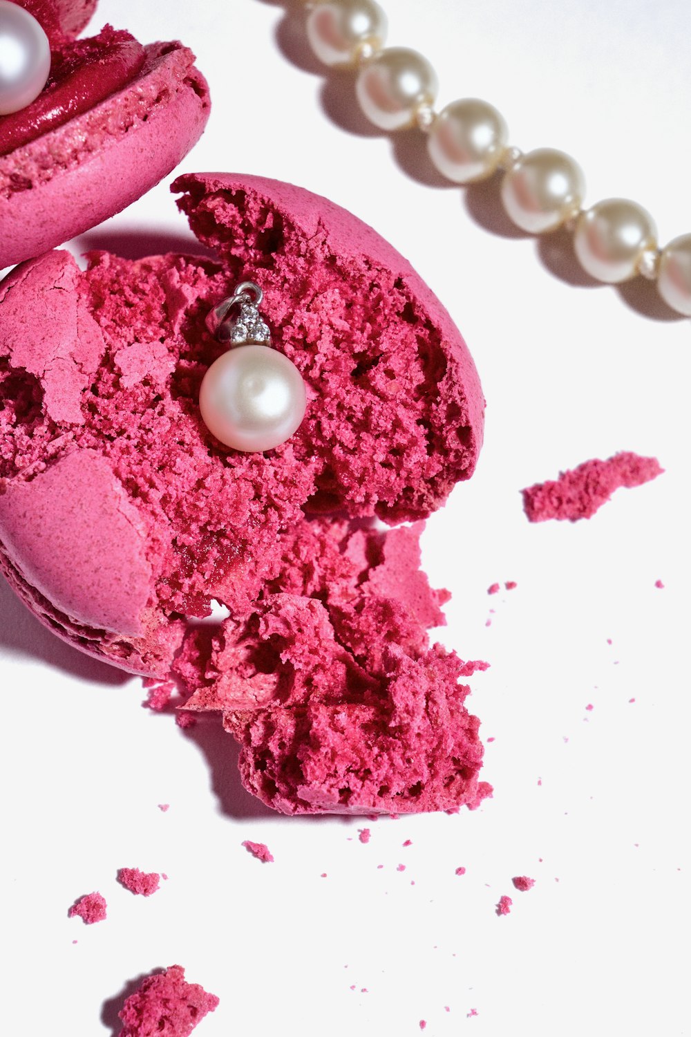 a close up of a piece of cake with a pearl necklace