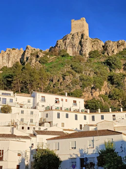 Sunset over a charming Andalusian village with whitewashed houses and terracotta roofs.