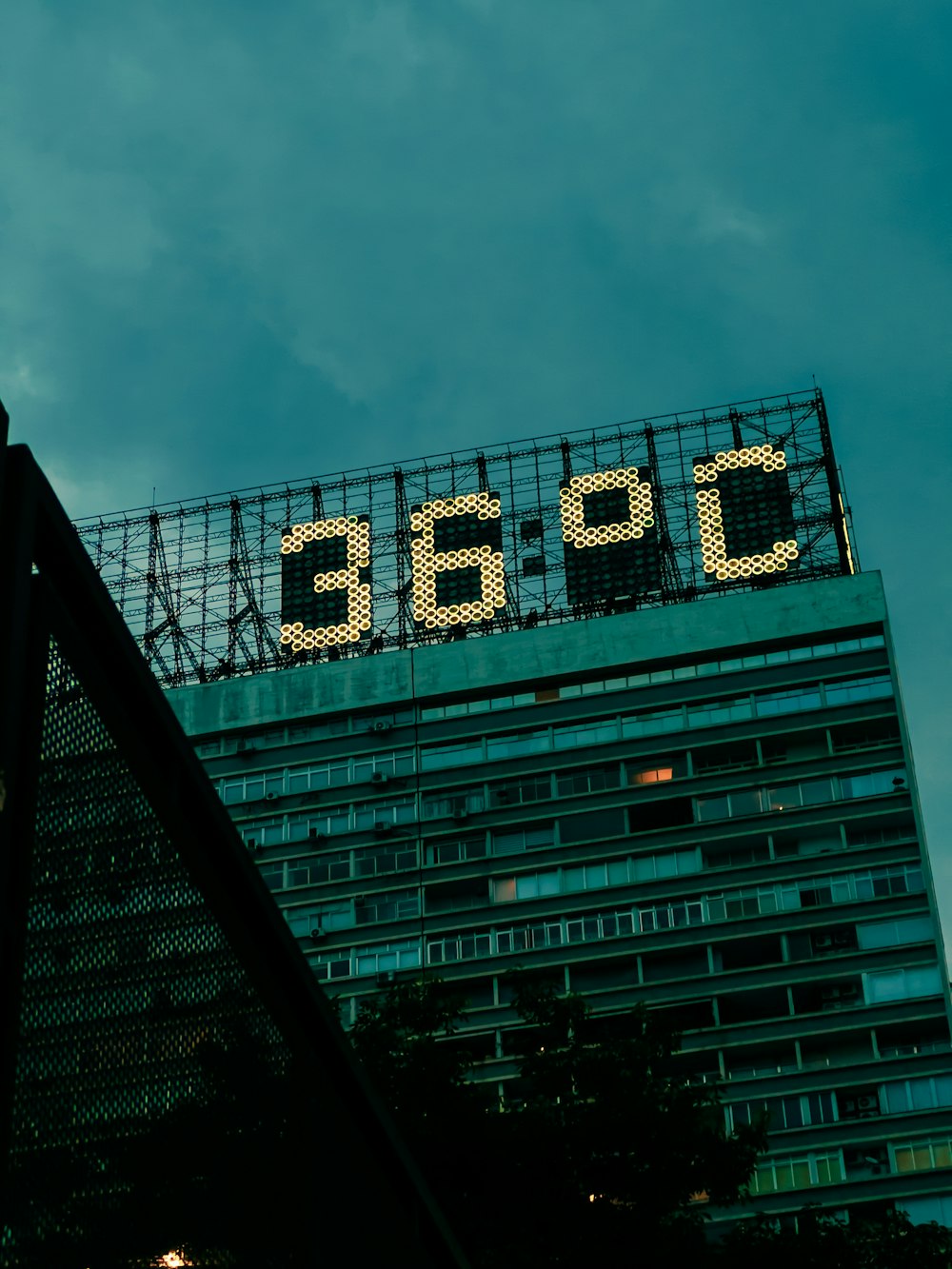 a tall building with a sign on top of it