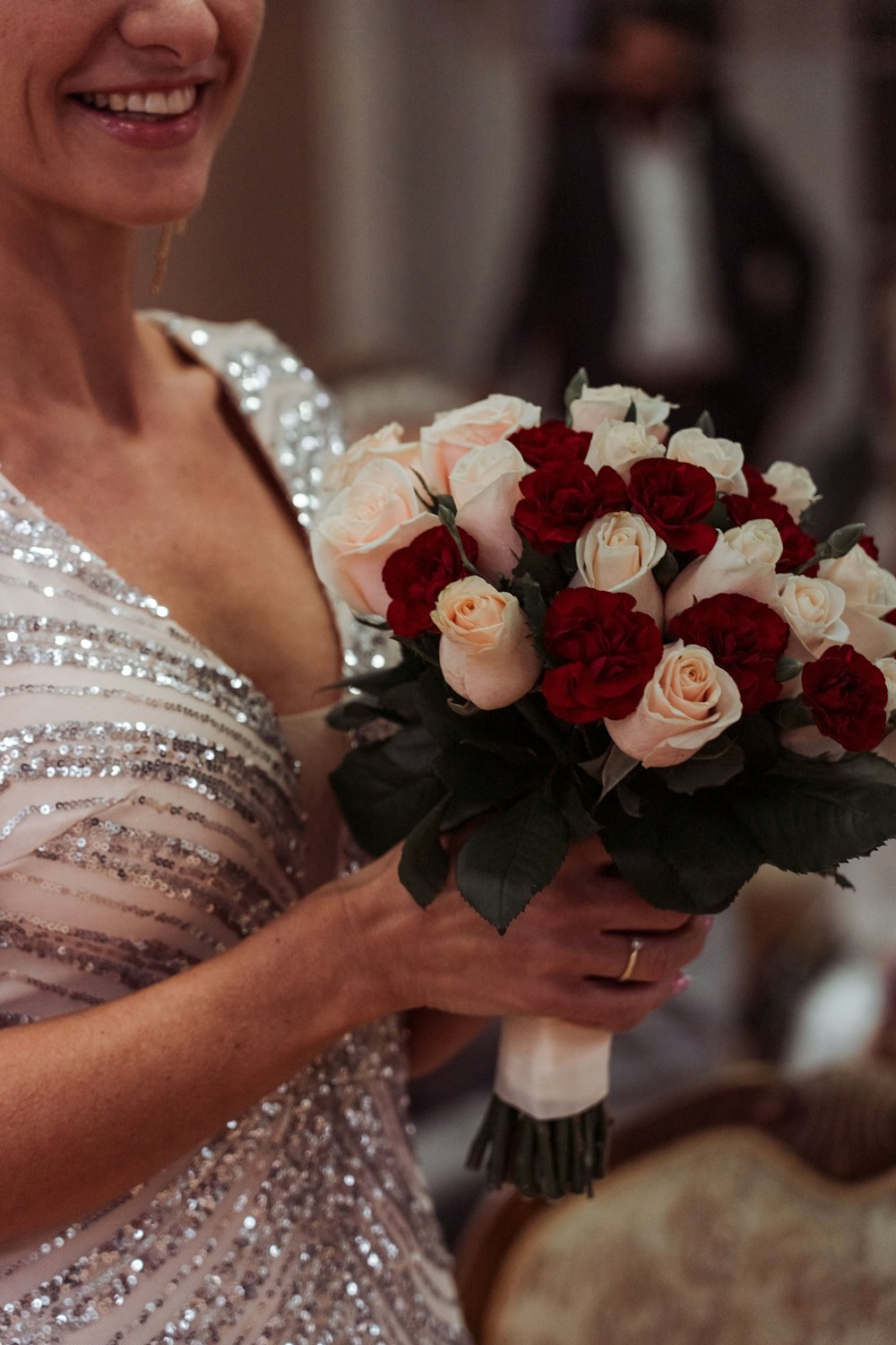 a woman holding a bouquet of roses in her hands