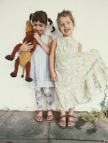 Children playing happily wearing vibrant and comfortable outfits.