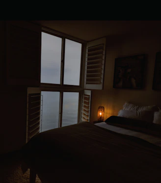 Cozy bedroom with deep navy blackout curtains softly blocking morning light