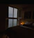 Cozy bedroom with soft natural light and sea view from the window.