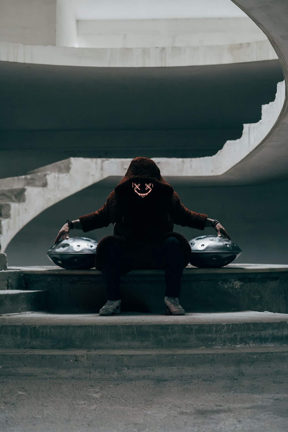 a person sitting on some steps with a skateboard