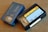 Two VHS-C video cassettes on a wooden surface. One is a Sony Premium 45 labeled case with blue coloring, and the other is a Fuji High Quality Plus HO+ EC-45 with a black casing and yellow label.