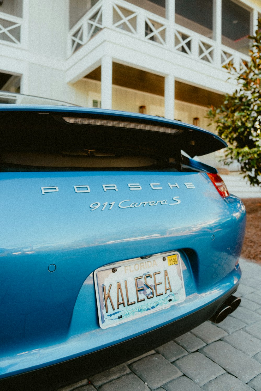 the back of a blue car with a license plate