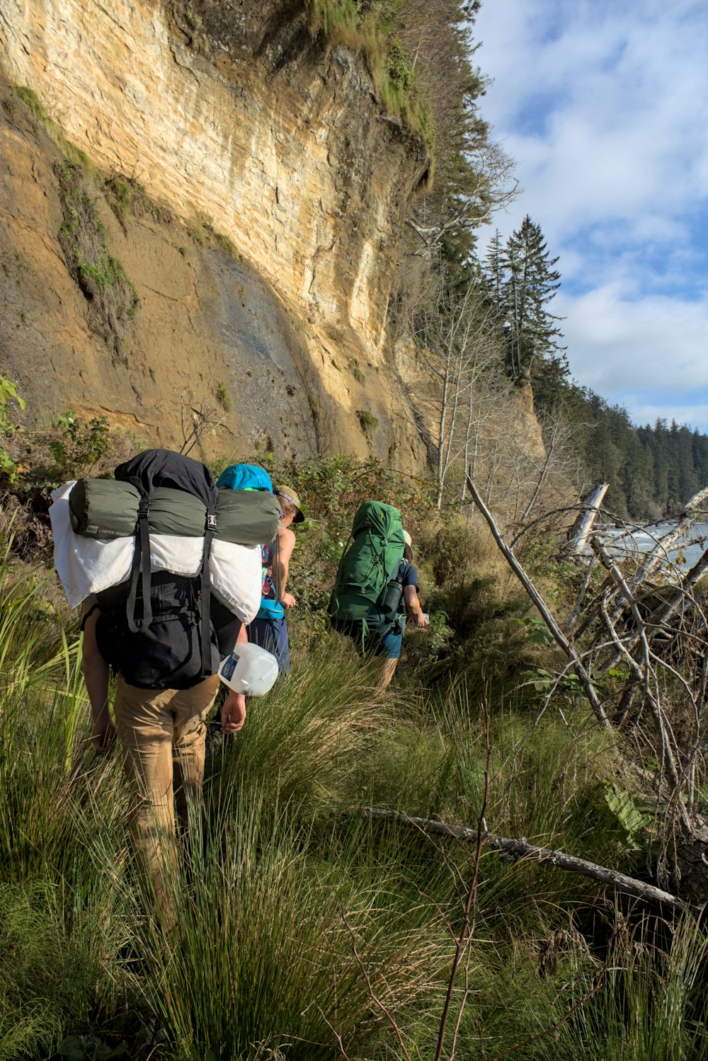 a group of people hiking up a steep hill