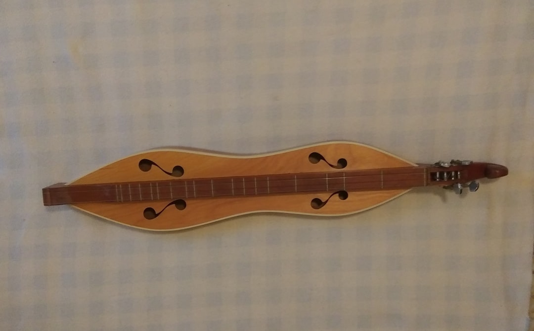 a wooden instrument is hanging on a wall,