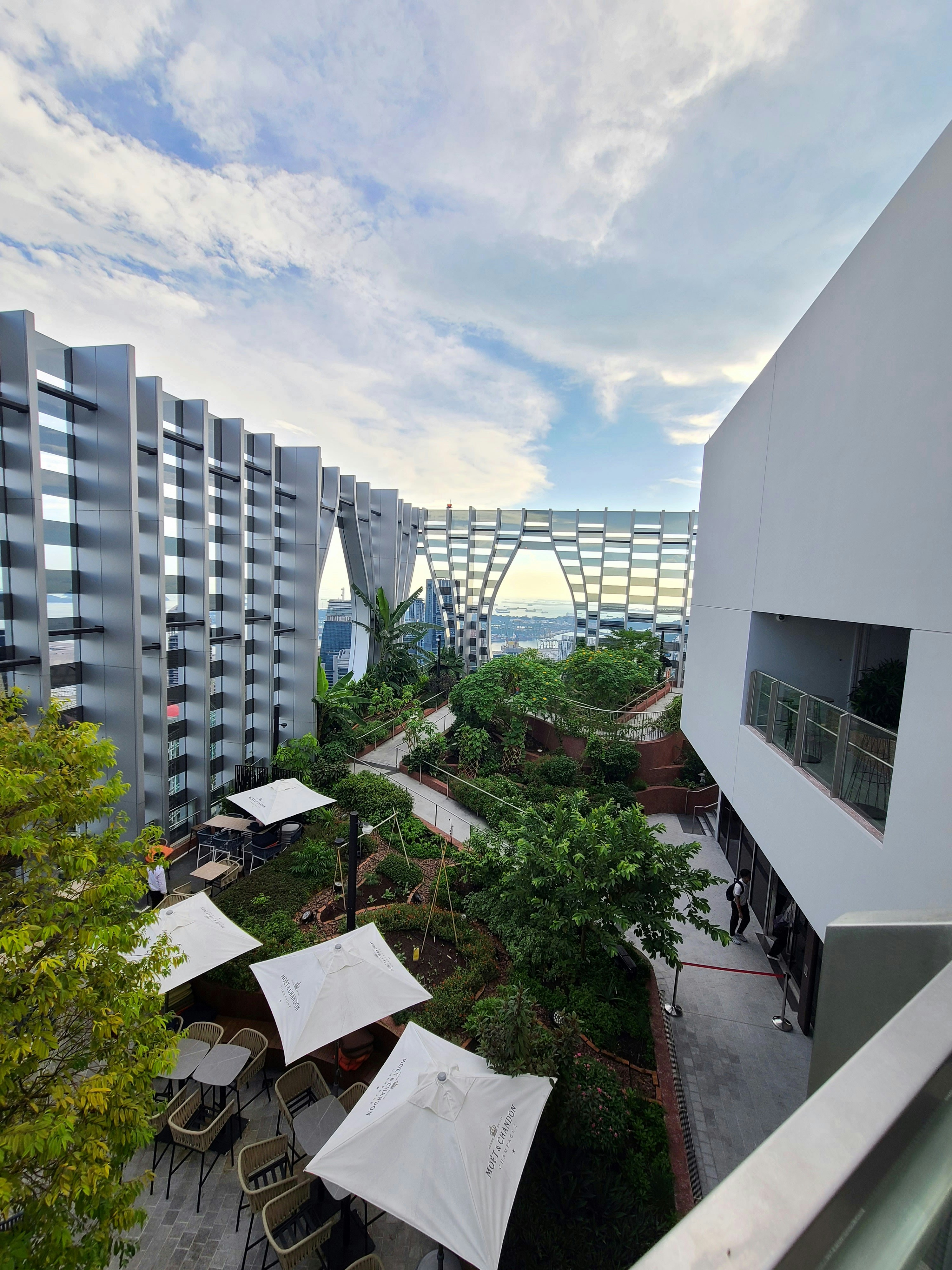 an aerial view of a building with tables and umbrellas