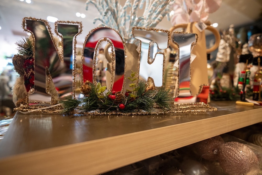 a wooden shelf topped with christmas decorations and letters