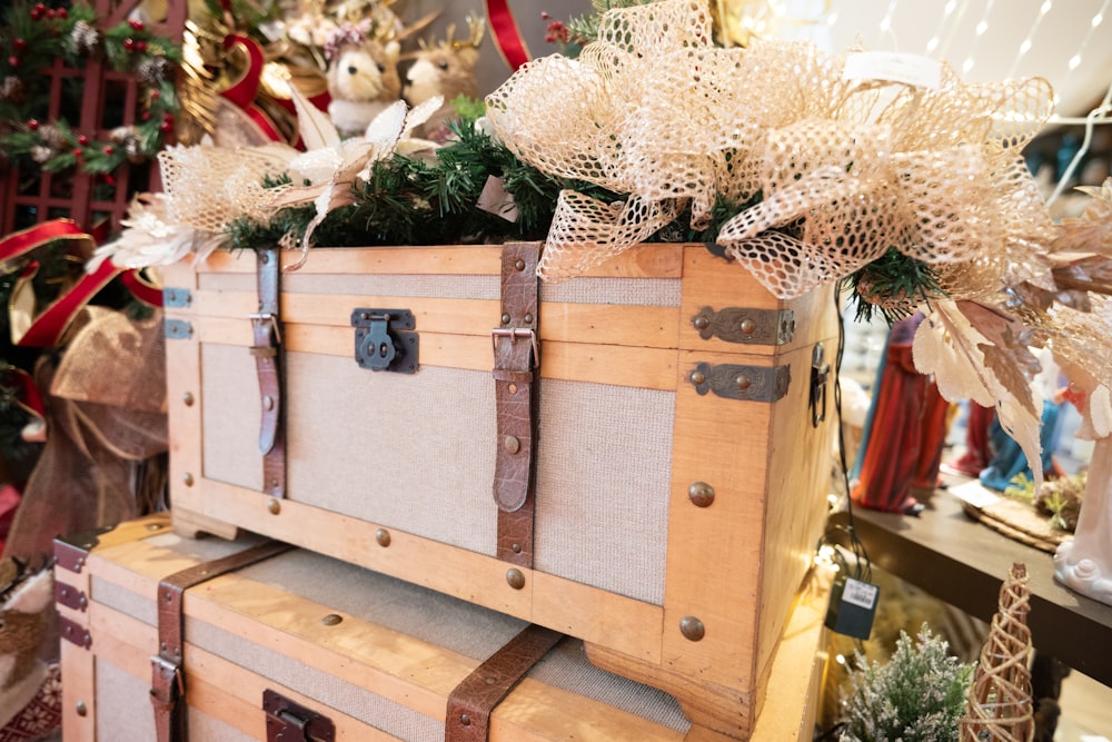 a wooden trunk with a bunch of flowers on top of it