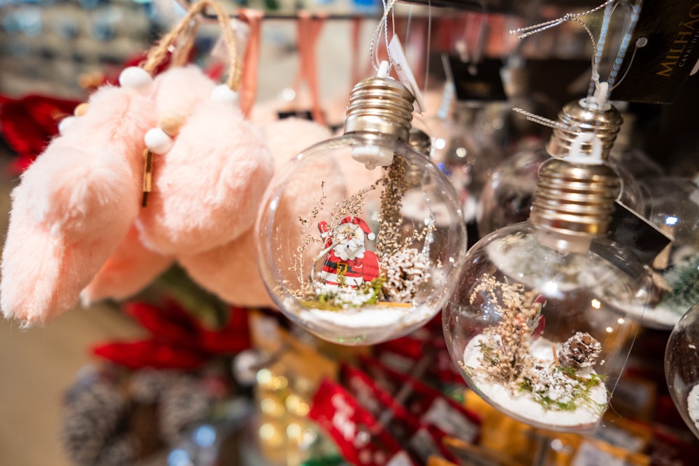 a bunch of christmas ornaments hanging from a rack