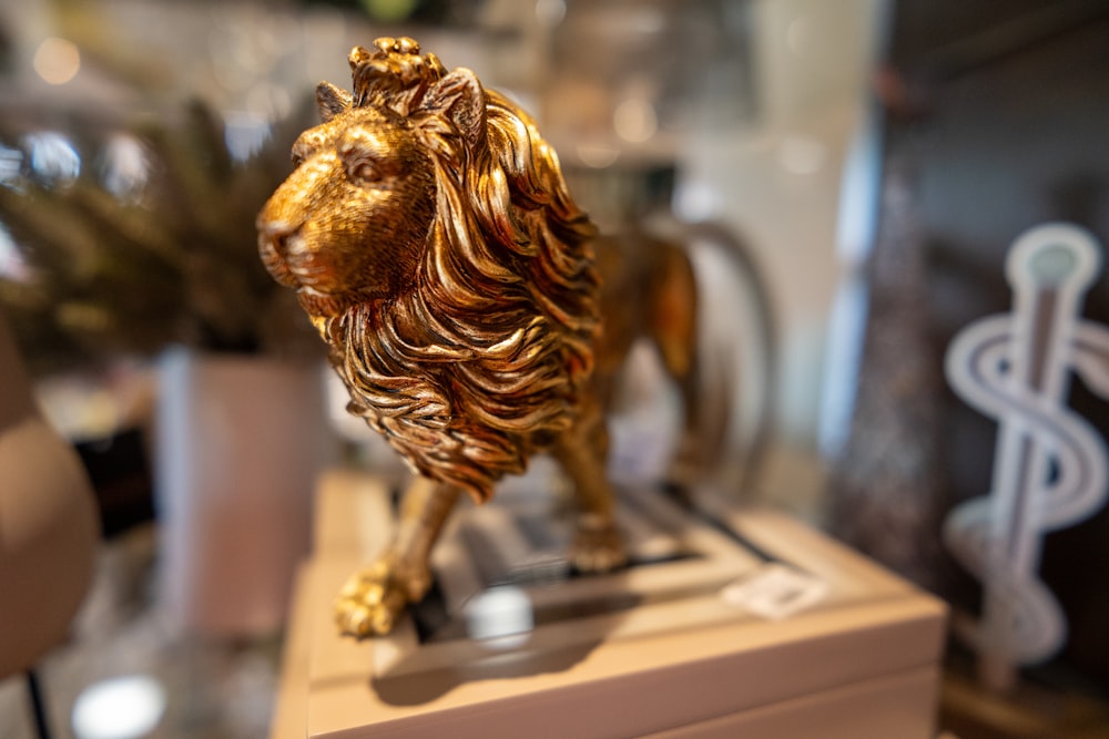 a golden lion statue sitting on top of a table