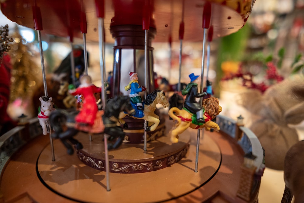 a merry go round with figurines on it