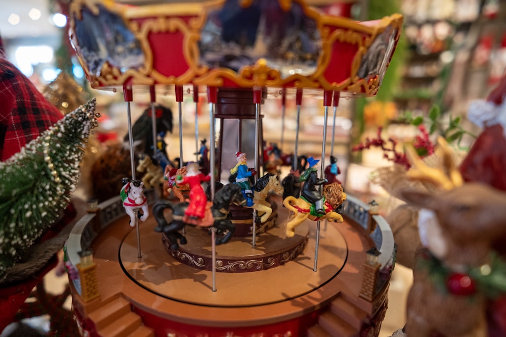 a merry go round with figurines on top of it