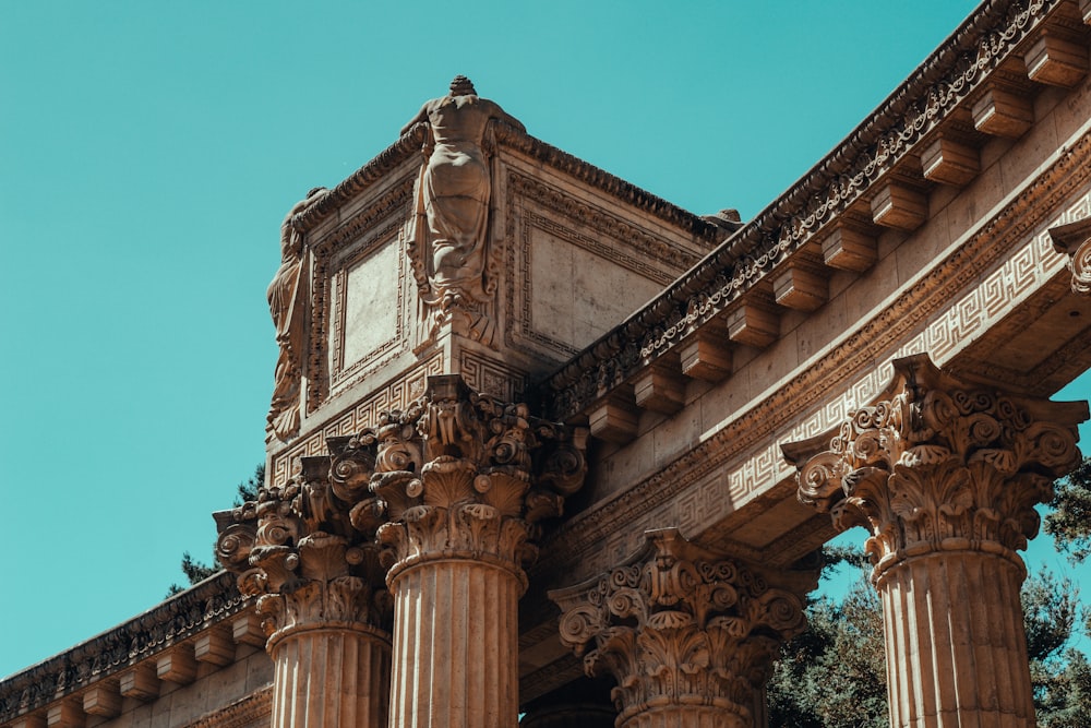 an old building with columns and a clock on the side