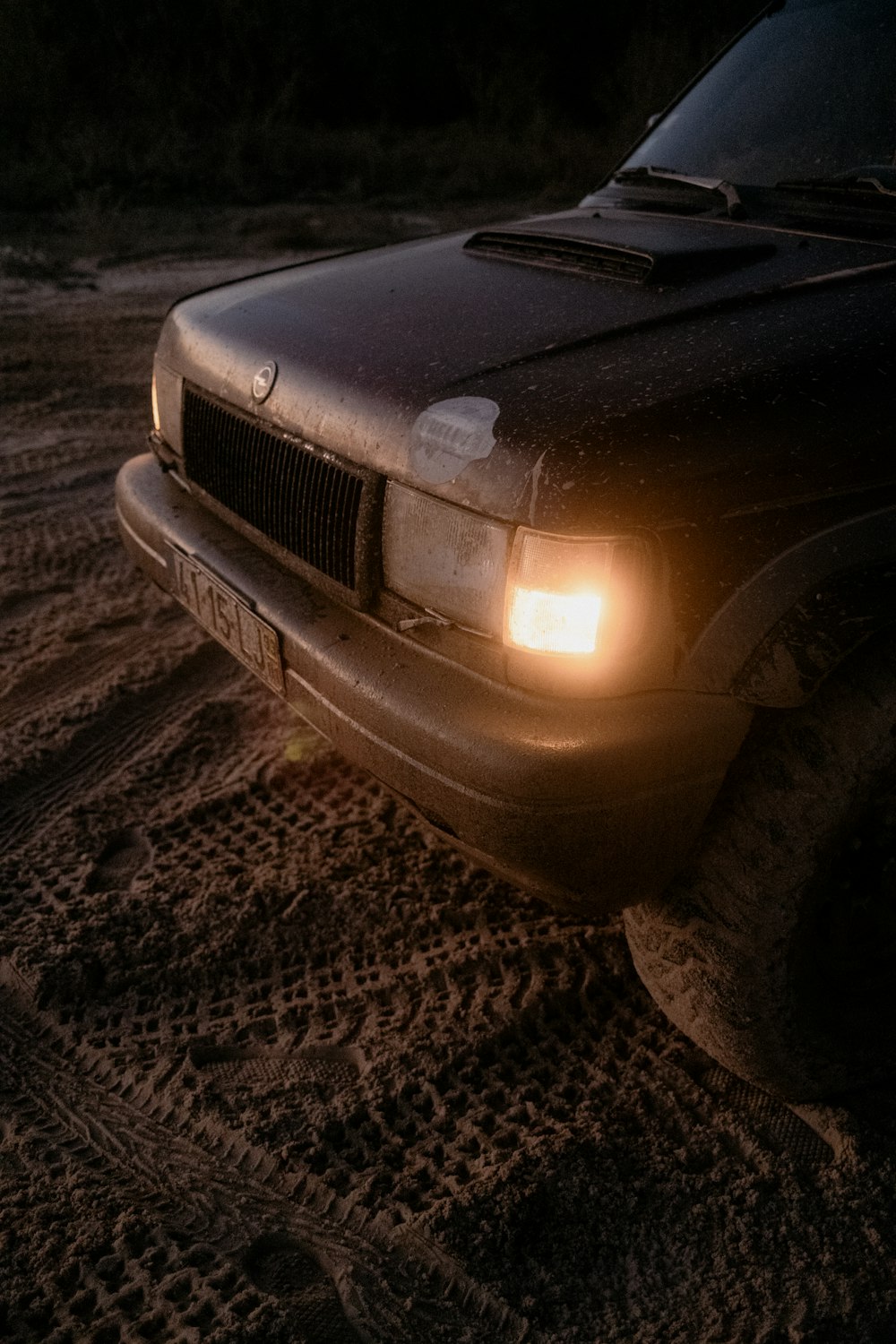 a truck is driving through the mud at night