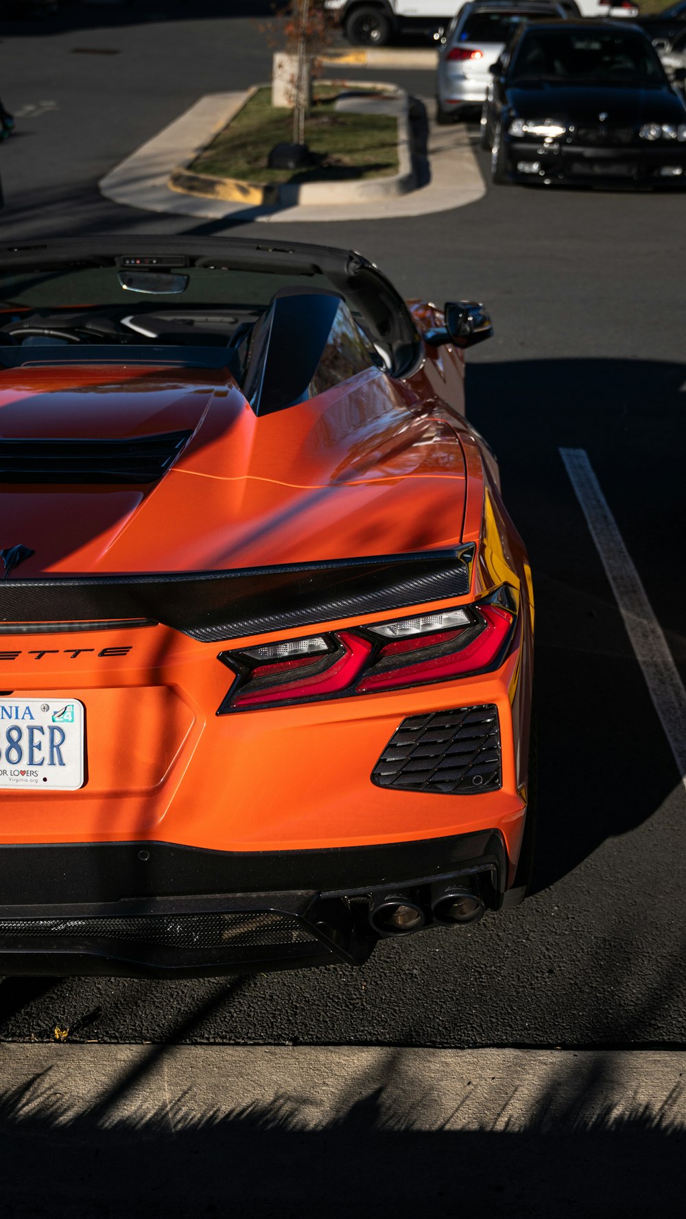 an orange sports car parked in a parking lot