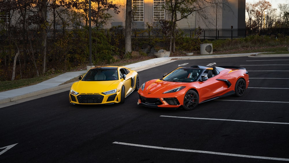 two orange and yellow sports cars parked in a parking lot