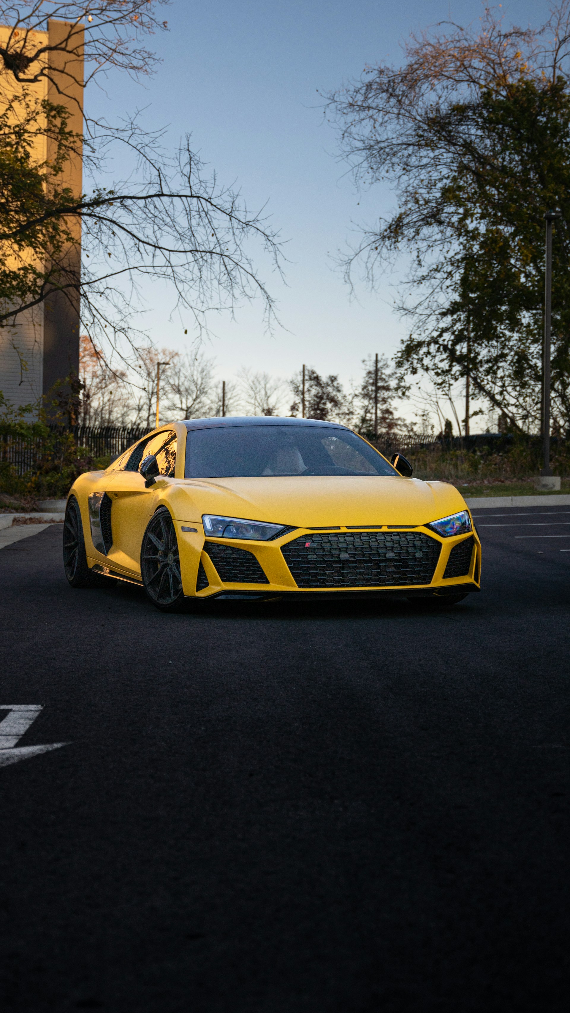a yellow sports car parked in a parking lot