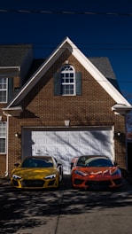 two cars parked in front of a house
