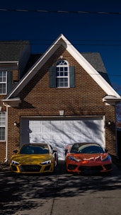 two cars parked in front of a house