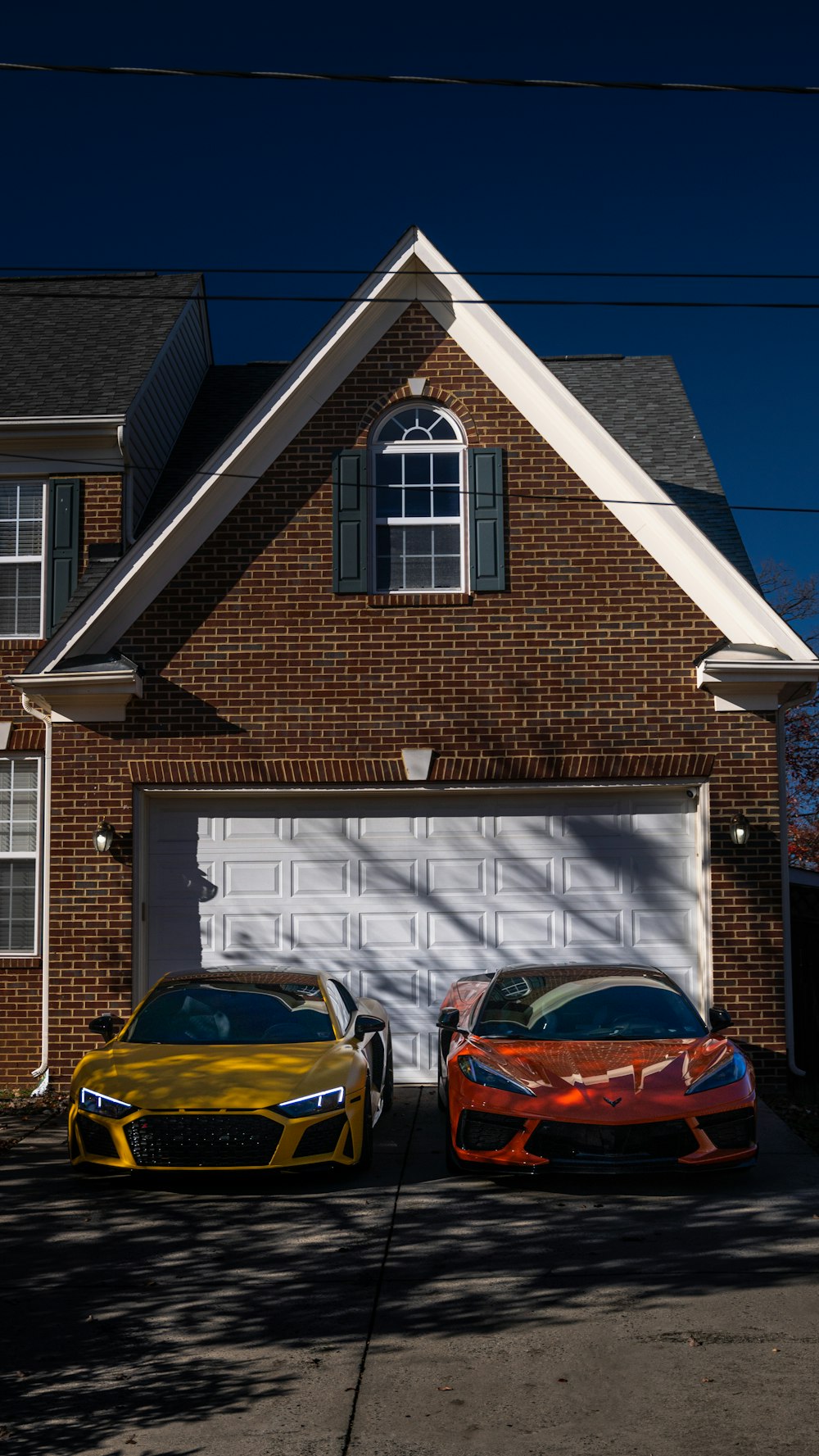 two cars parked in front of a house