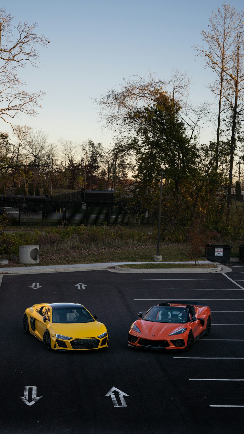 two cars parked in a parking lot next to each other