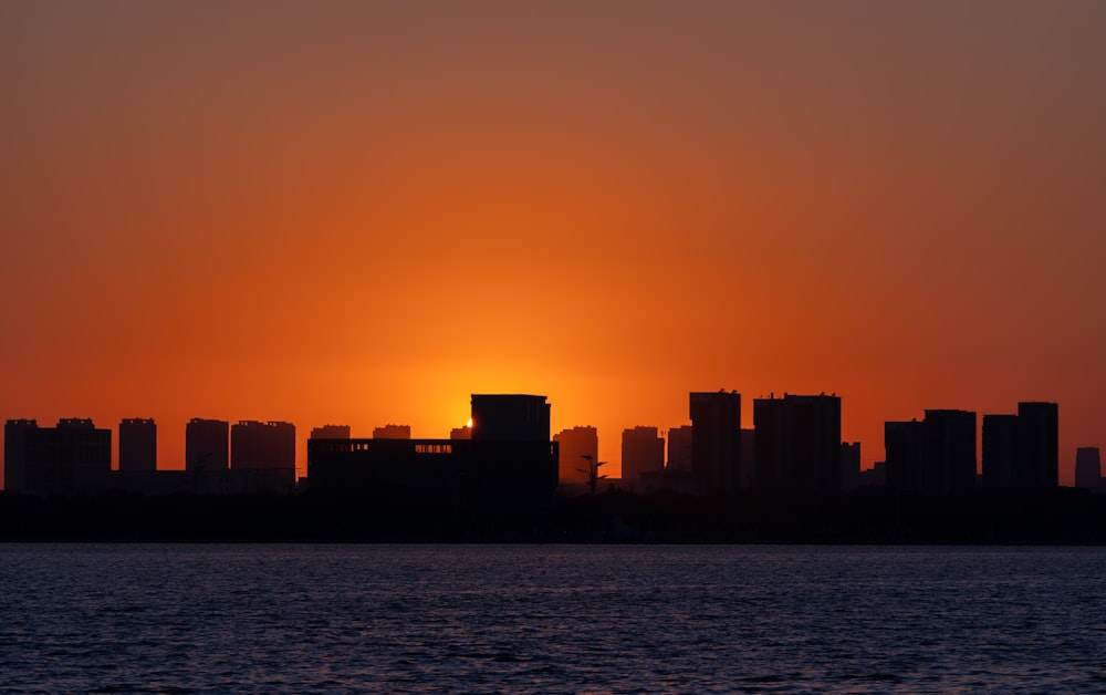 the sun is setting over a large city