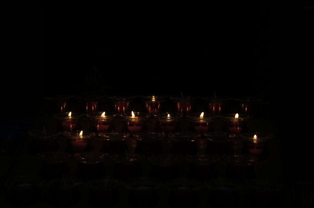 a group of lit candles sitting on top of a table