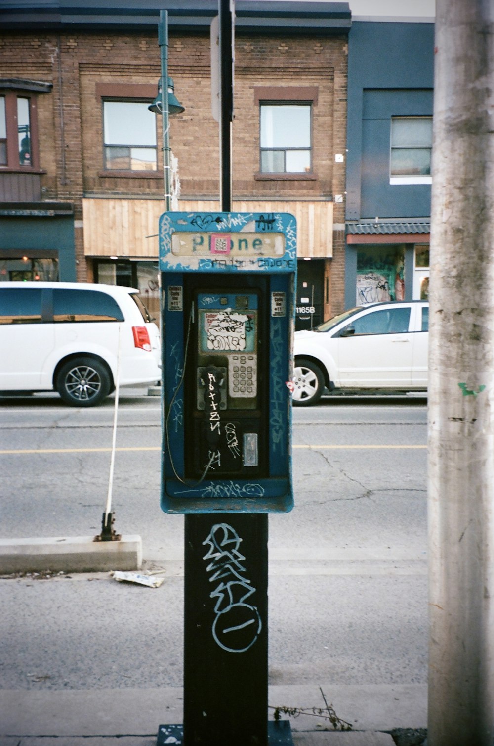 a parking meter sitting on the side of a street