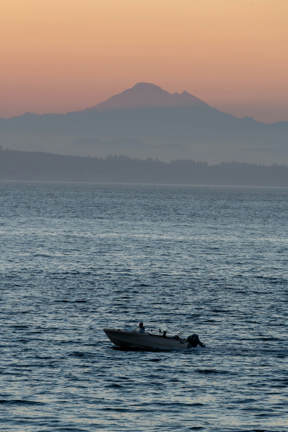 a small boat in the middle of a large body of water