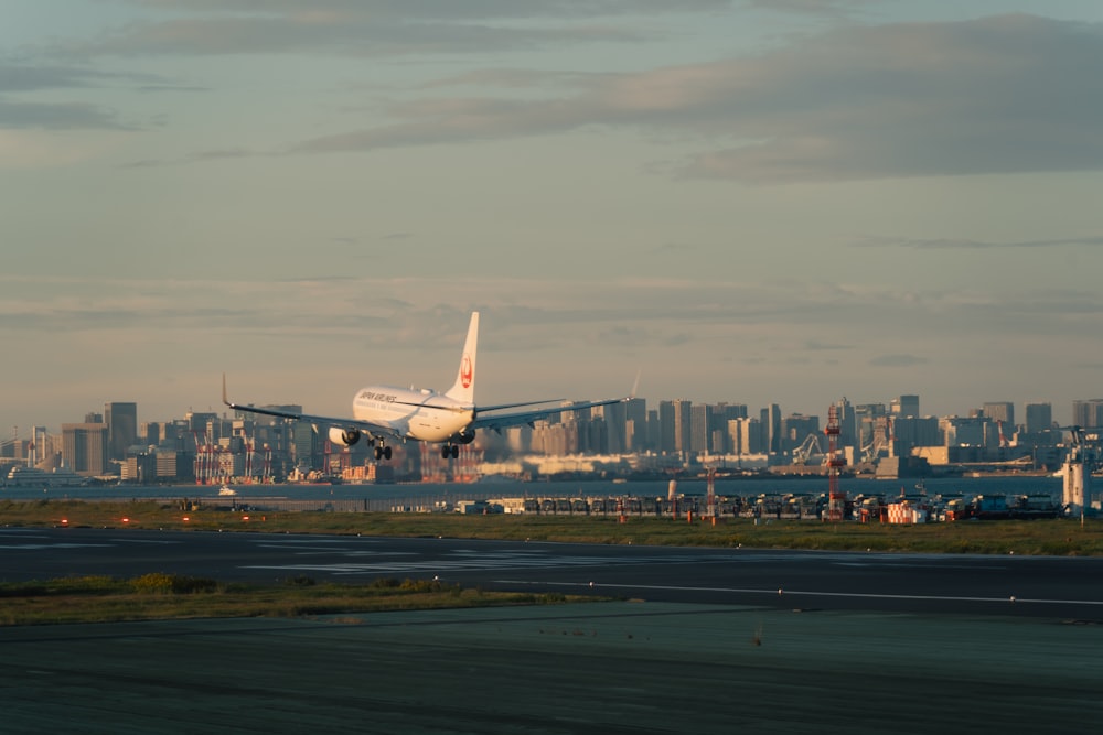 a large passenger jet flying over a city