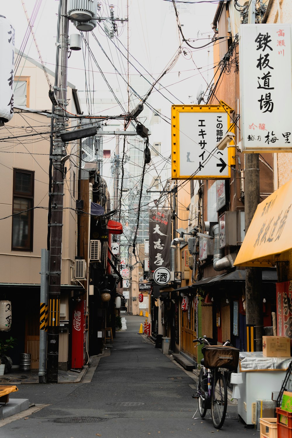 a city street with lots of power lines above it