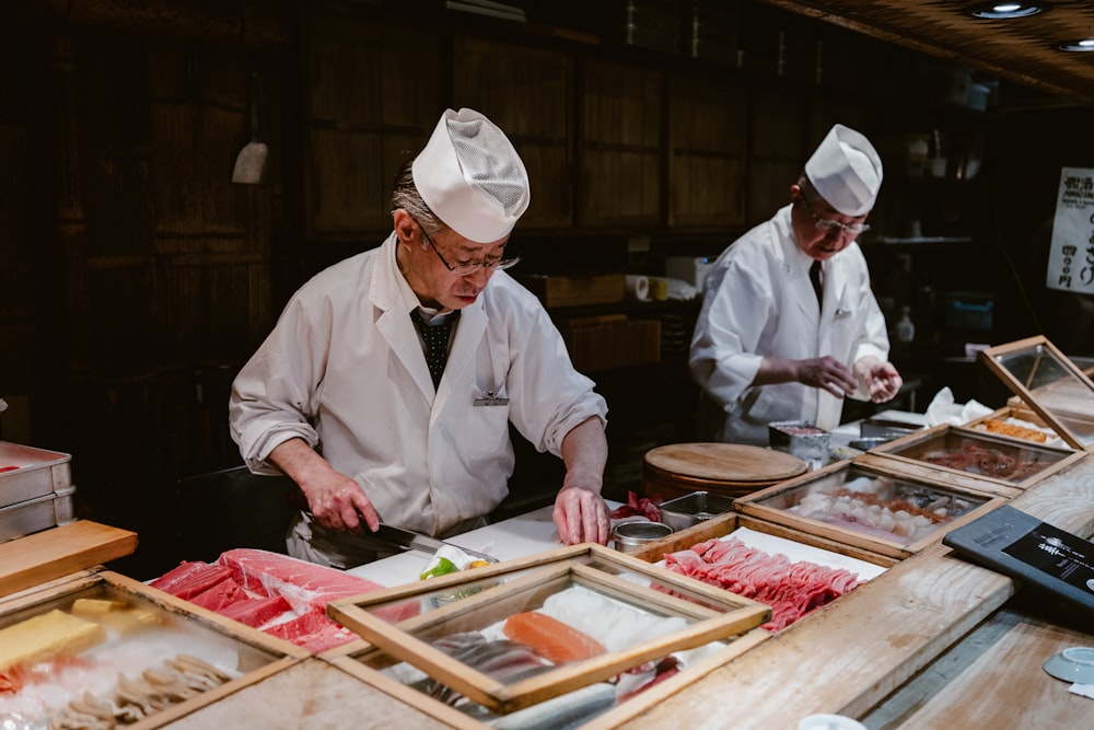 two chefs preparing food in a restaurant kitchen