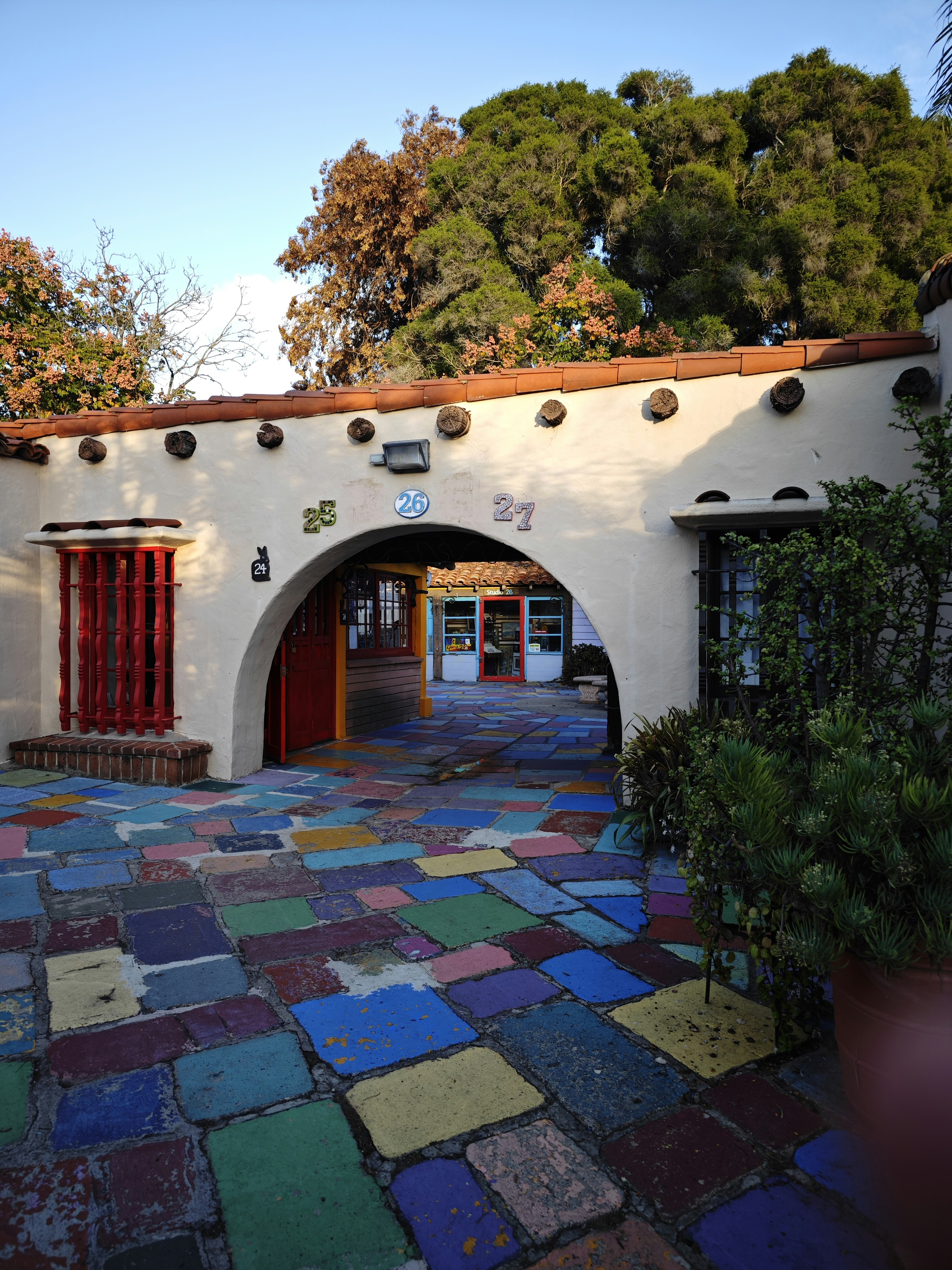 a white building with a red door and red shutters