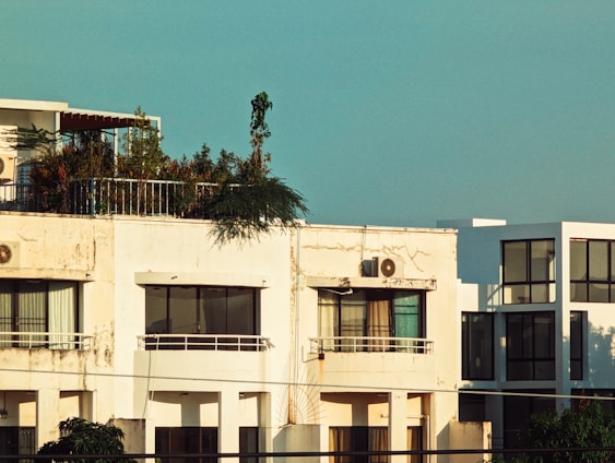 Urban apartment building with rooftop terrace and city skyline