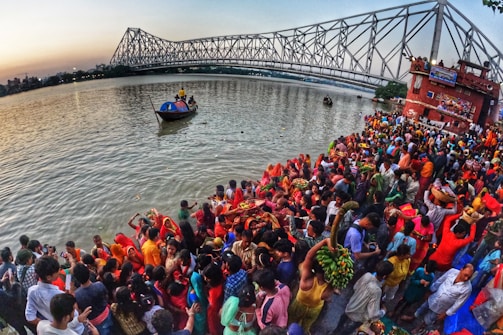 Community members raising the festive mast during the São Francisco de Assis celebration by the river.