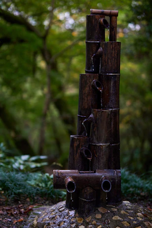 A tranquil water feature with gentle ripples reflecting bamboo stalks.