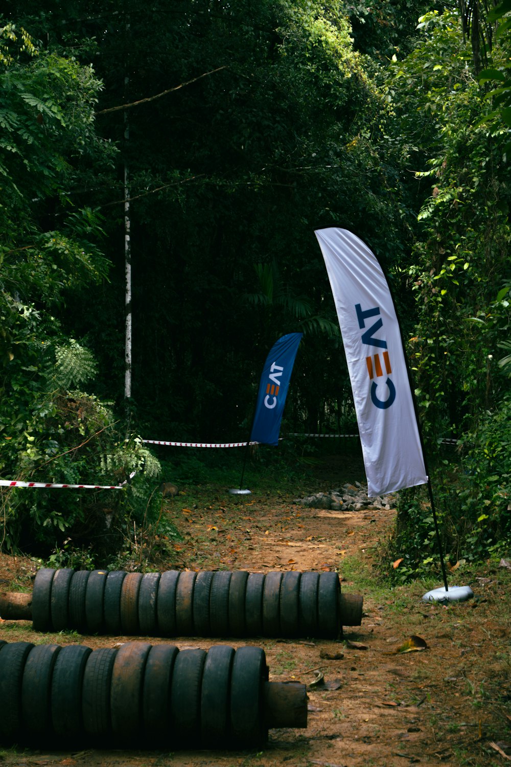 a group of tires sitting on top of a dirt road