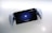 A handheld gaming device is positioned against a white background. The device features a screen displaying a PlayStation logo with the prompt 'To unlock, press the PS button.' It is framed by white controllers on both sides, resembling a hybrid of a tablet and a console.