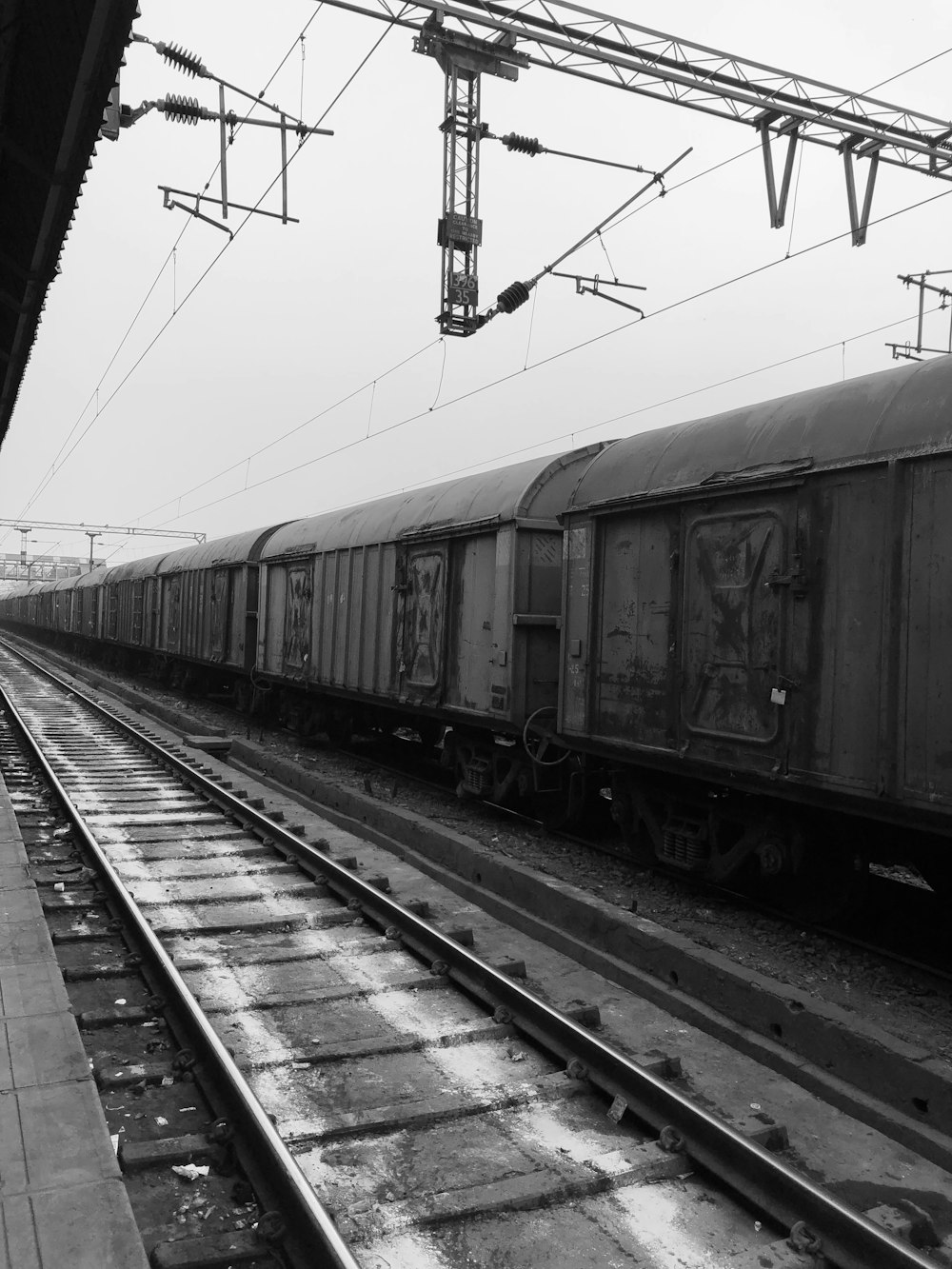 a black and white photo of a train on the tracks