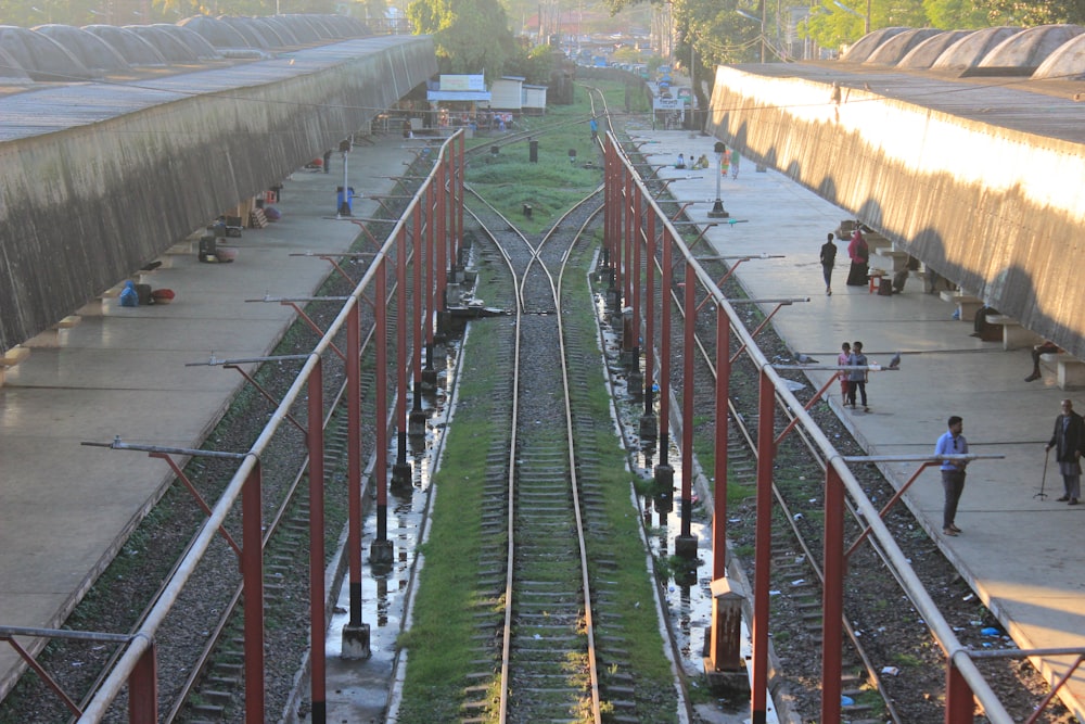 a train yard with people walking on the tracks