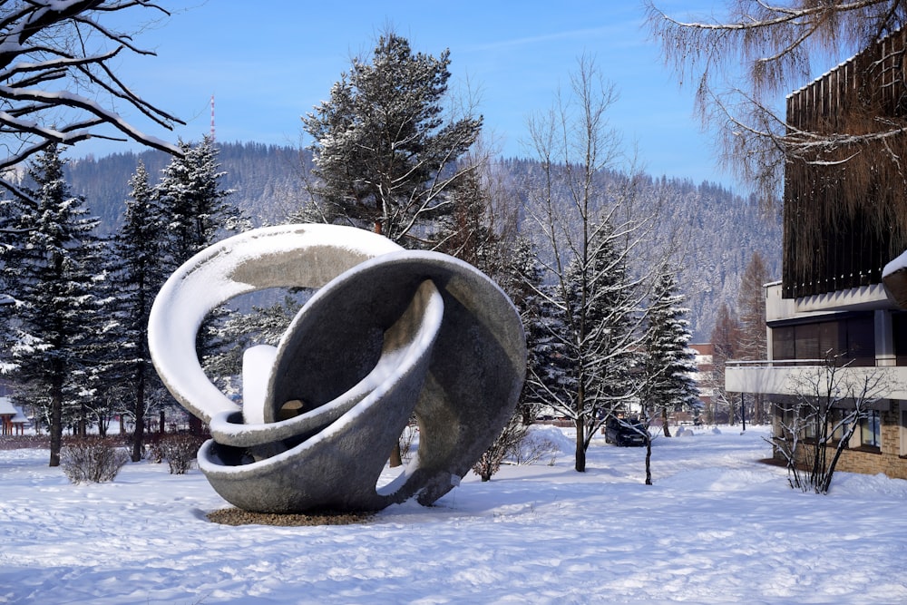 a sculpture in the middle of a snowy park