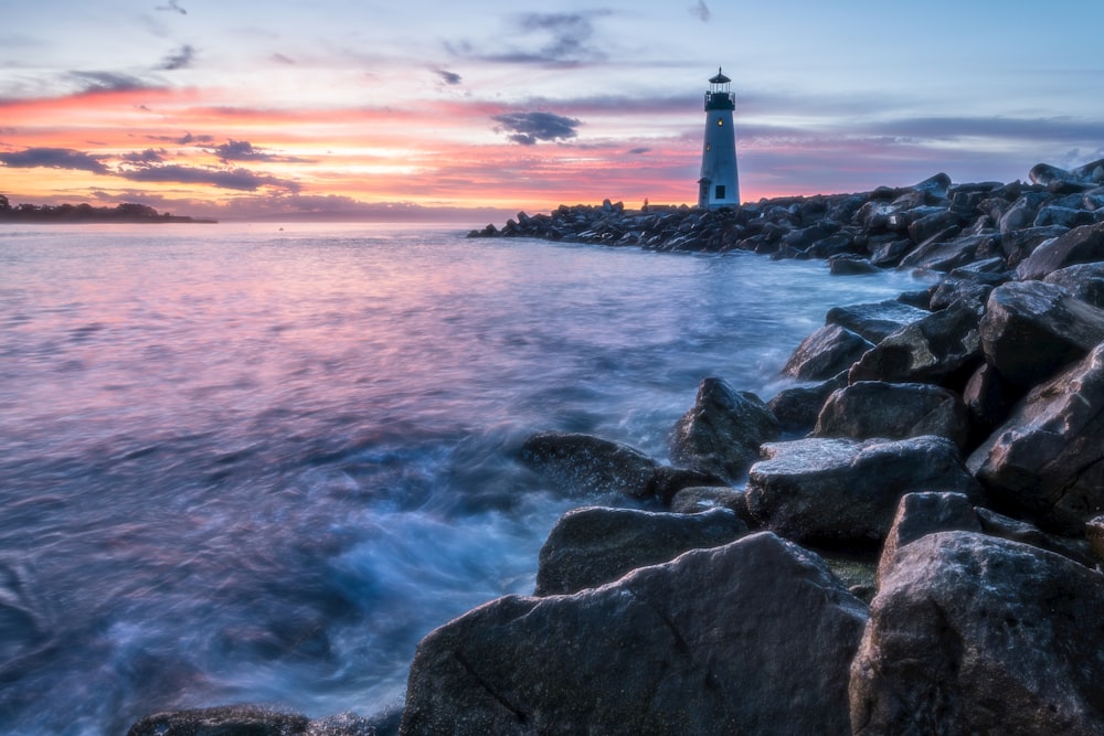 a light house sitting on top of a rocky shore